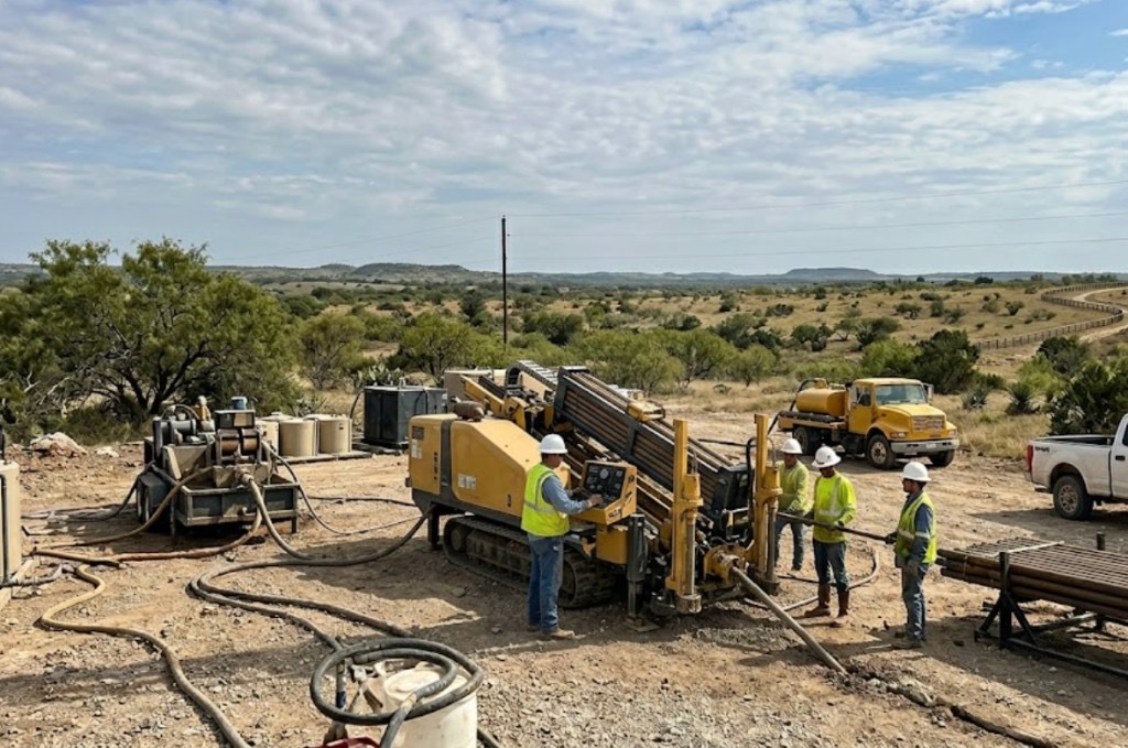 Directional drilling and directional boring in Oklahoma — yellow HDD rig and crew performing directional drilling on a rural Oklahoma utility job site